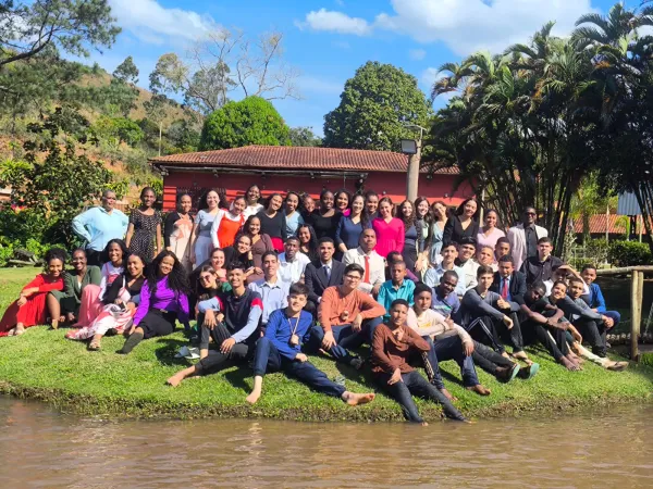 Grupo de jovens reunido para foto na beira do lago do sítio
